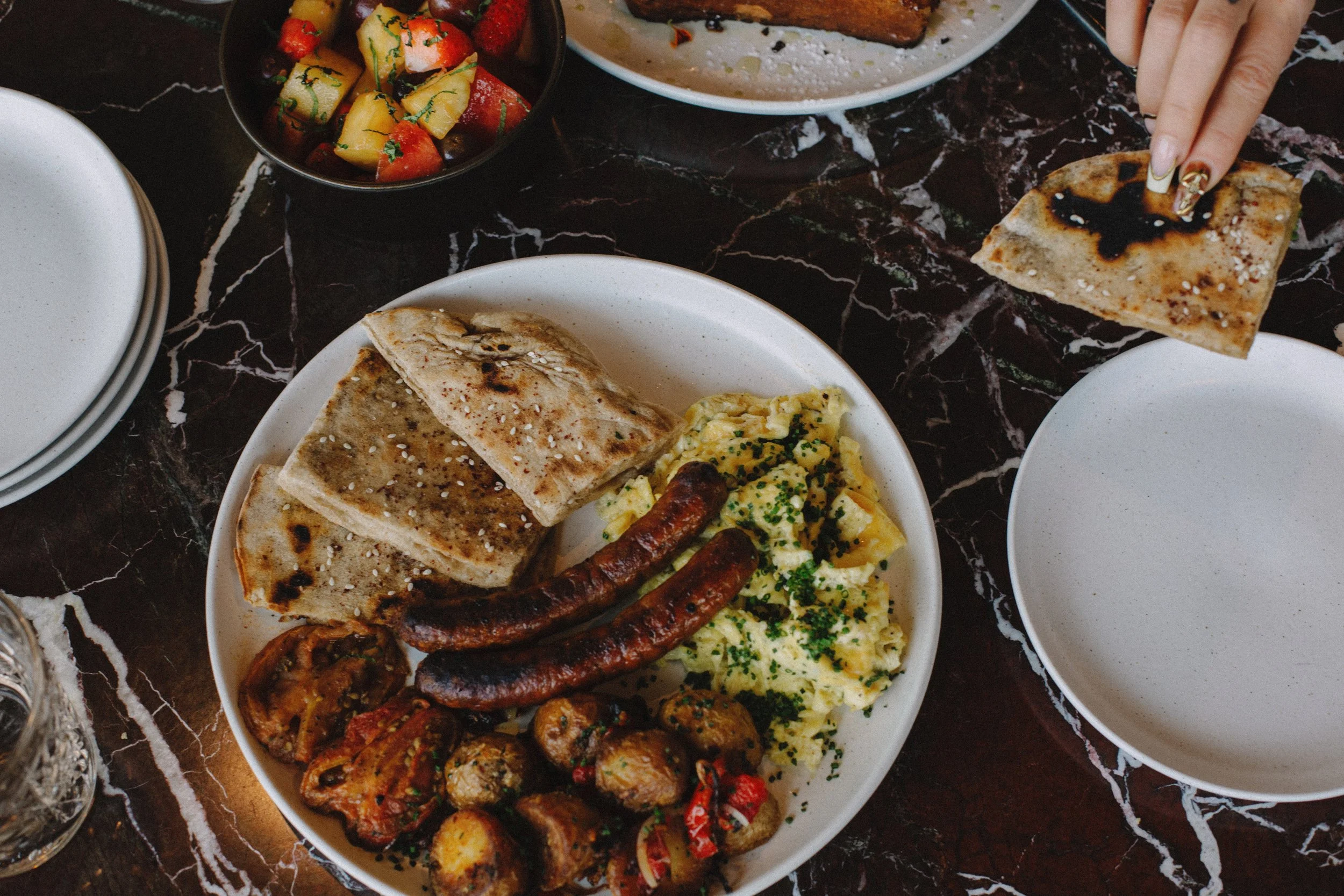 Egg plate with lamb merguez sausage and sourdough pita