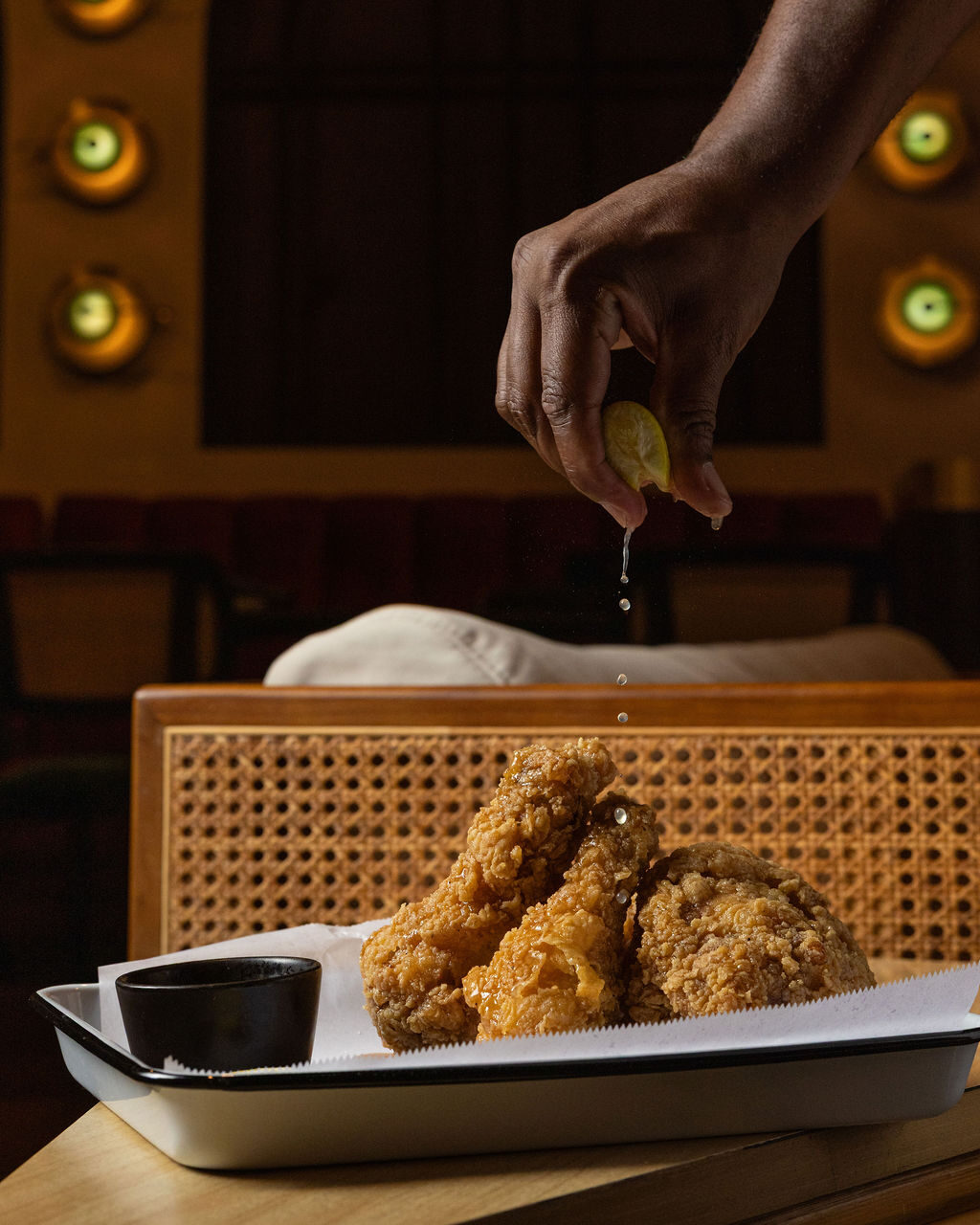 A squeeze of lemon over fried chicken at Stereo 41
